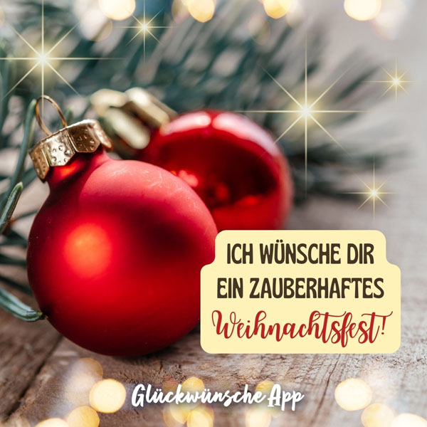 Rote Weihnachtskugeln auf dem Weihnachtsbaum mit Weihnachtswunsch "Ich wünsche dir ein zauberhaftes Weihnachtsfest!"