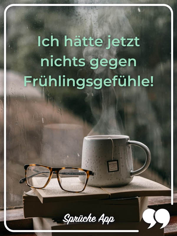 Tasse mit Tee vor einem Fenster und Spruch: „Ich hätte jetzt nichts gegen Frühlingsgefühle!"